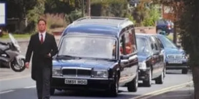 Traditional funeral hearse and limousine in Hereford